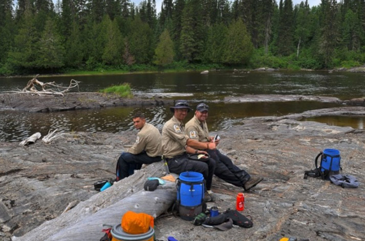 Staff sitting by a river