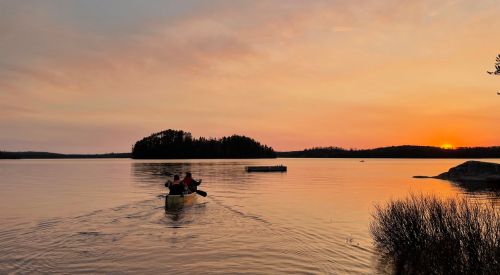 canoe on lake at sunset