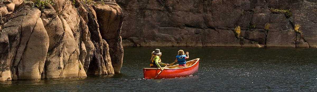 Two people canoeing on a lake