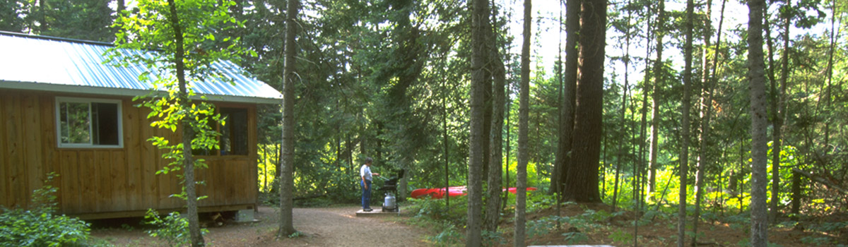 Person grilling on bbq at a cabin