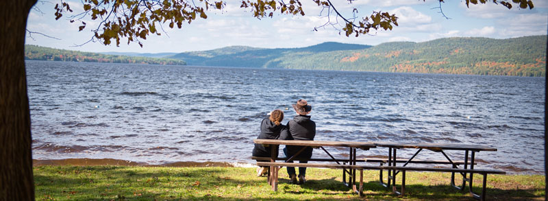 sitting on a picnic table at the lake