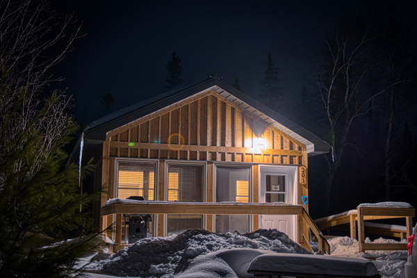 Windy lake cabin at night