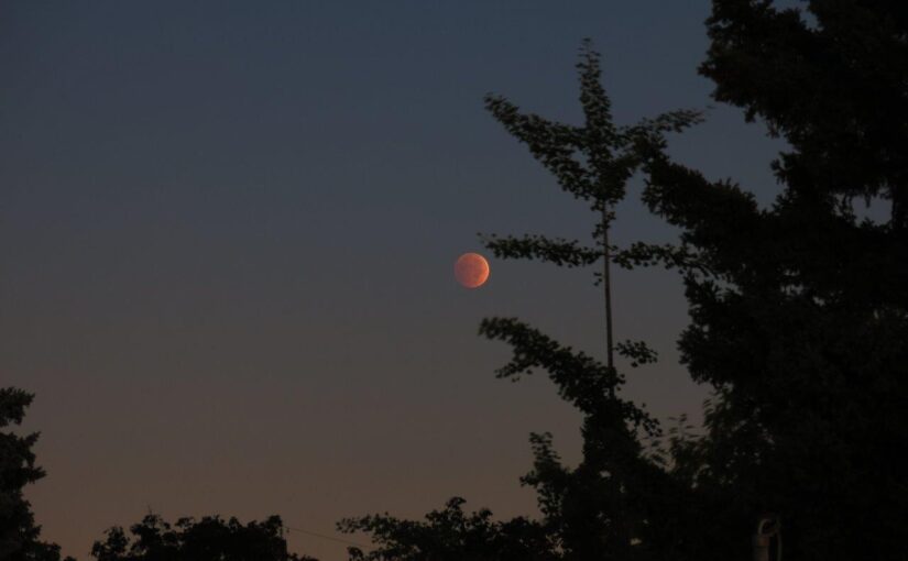 The moon tinged orange during a lunar eclipse