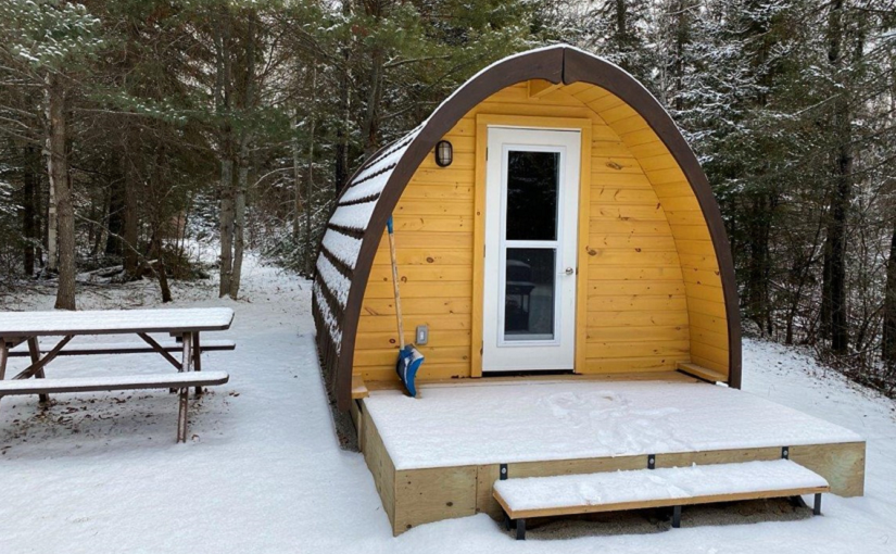 camping pod on campsite covered with dusting of snow